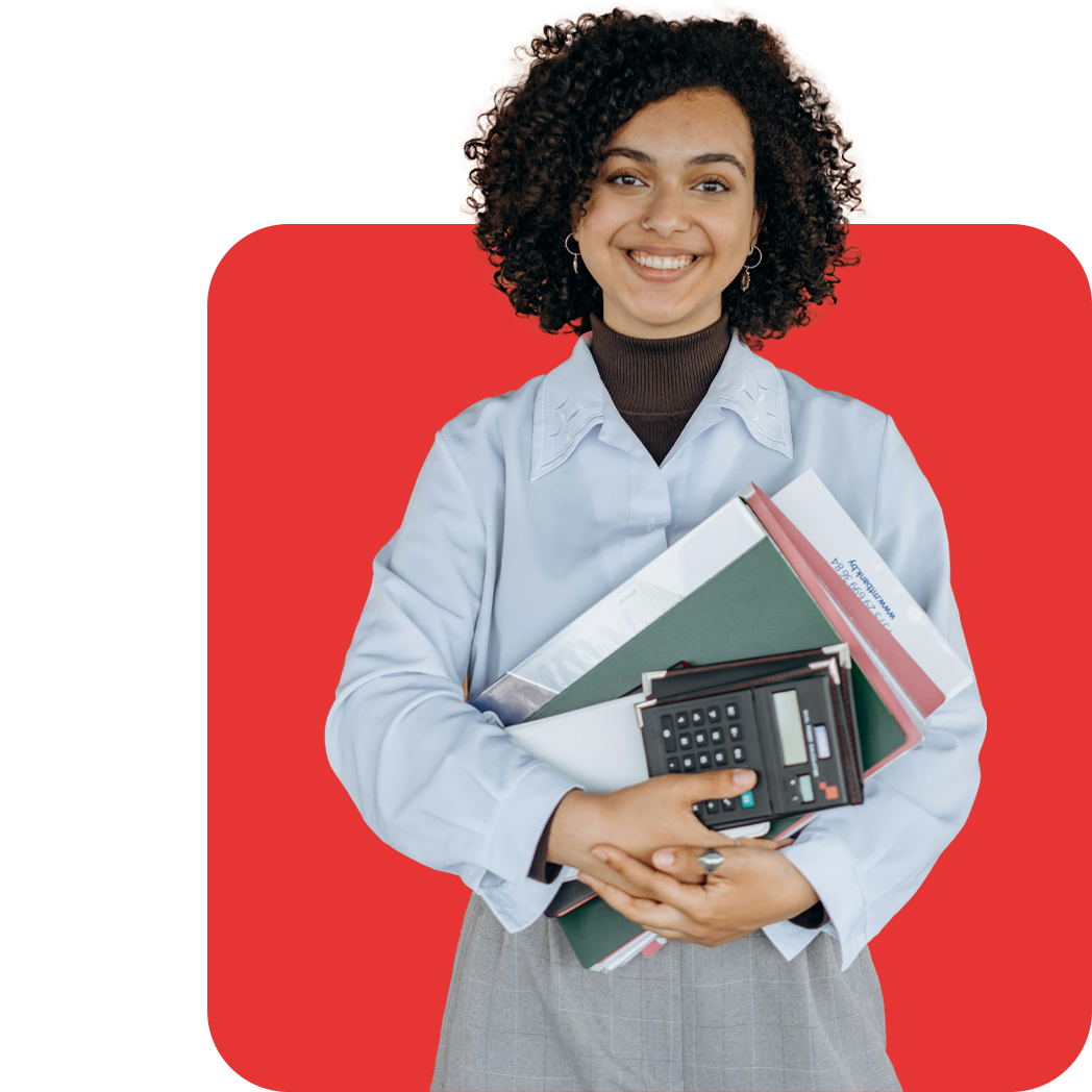 A person with curly hair holds books and a calculator, showcasing the precision demanded by the best outsourced accounting services in the USA, all set against a vibrant red background.